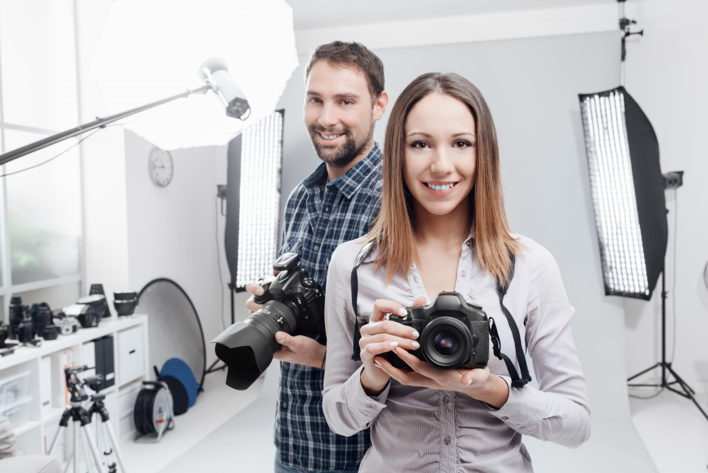 two photographers smiling